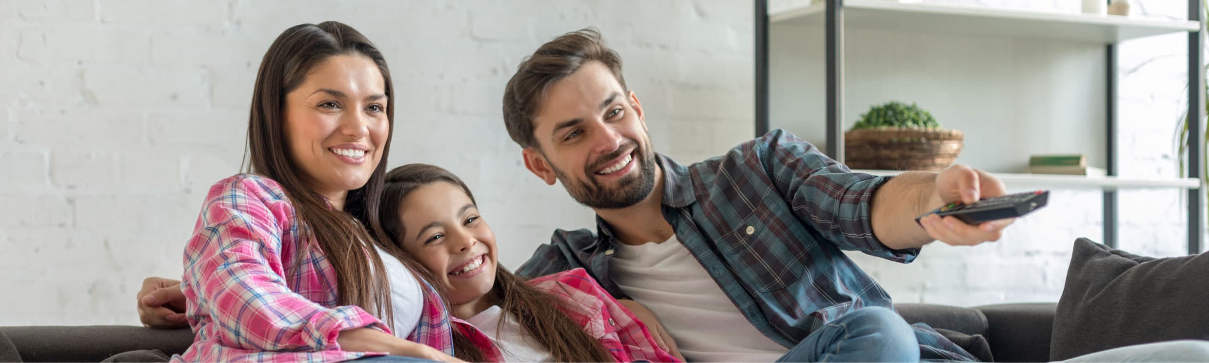 Family of three enjoying watching streaming content.