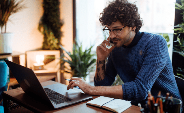 Man using ToldeoTel's fast business internet while working on a laptop.